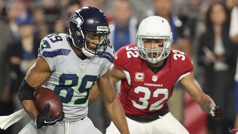 GLENDALE, AZ - OCTOBER 23:  Wide receiver Doug Baldwin #89 of the Seattle Seahawks runs after the catch under pressure from free safety Tyrann Mathieu #32 