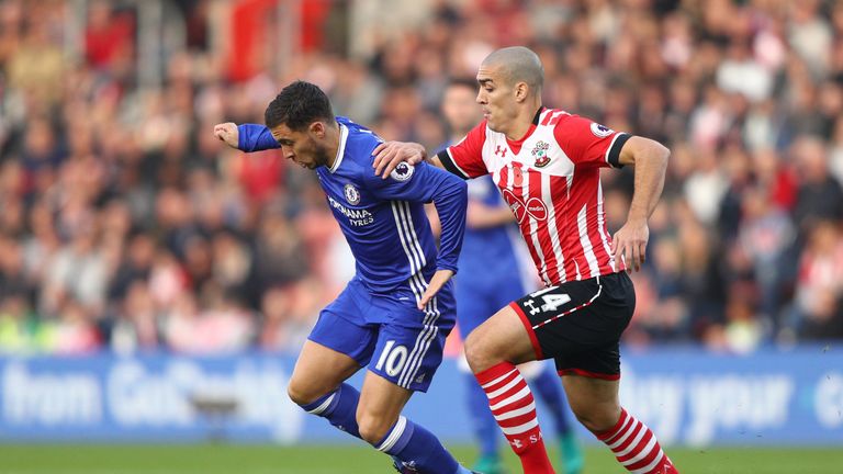 Eden Hazard of Chelsea (L) is challenged by Oriol Romeu of Southampton 