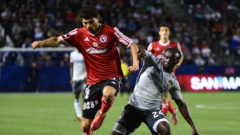 CARSON, CA - FEBRUARY 09:  Miguel Rodriguez #285 of Club Tijuana jumps over the leg of Emmanuel Boateng #24 of the Los Angeles Galaxy during the first half