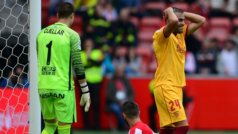 Sevilla's Argentinian defender Gabriel Mercado (R) reacts after missing a chance to score a goal during the Spanish league football match between Real Spor