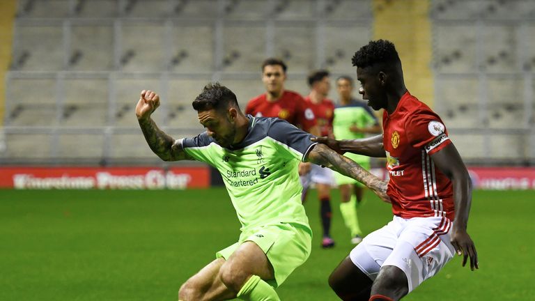 Danny Ings and Axel Tuanzebe in action during the Premier League 2 match between Manchester United and Liverpool