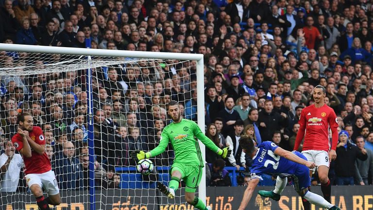 Chelsea's English defender Gary Cahill (2nd R) shoots past Manchester United's Spanish goalkeeper David de Gea (C) to score their second goal