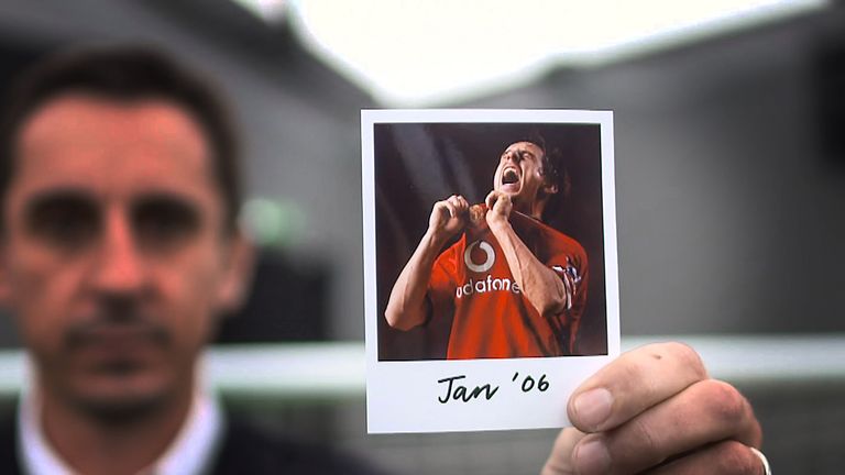 Gary Neville holds up a polaroid of himself kissing the Manchester United badge