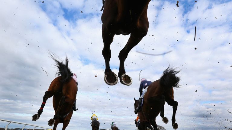 Horses and riders clear a fence during the New Racing UK iPad App Handicap Steeple Chase at Wetherby