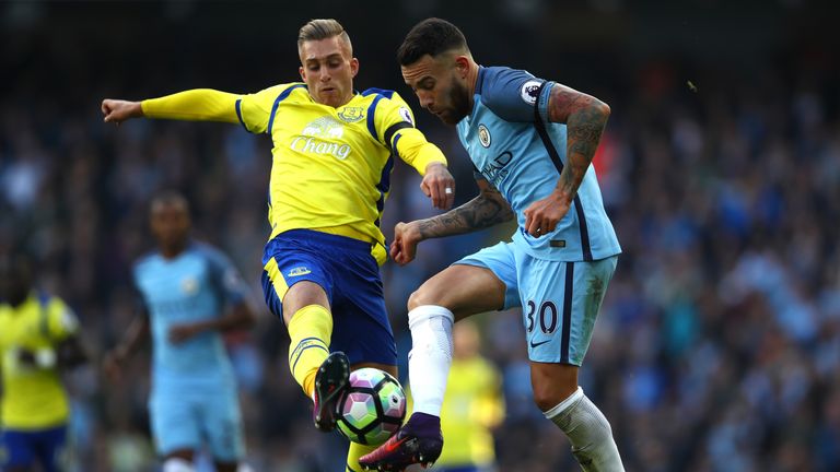 Gerard Deulofeu of Everton attempts to tackle Gael Clichy of Manchester City (R) during the Premier League clash