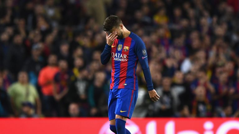 Gerard Pique of Barcelona leaves the pitch following an injury against Manchester City