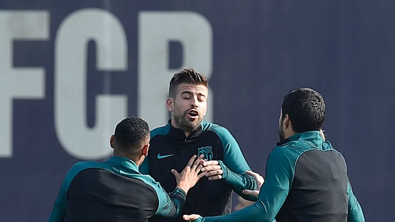 Barcelona's defender Gerard Pique (C) is pushed by Barcelona's Brazilian forward Neymar as he speaks with teammates during a training session at the Sports