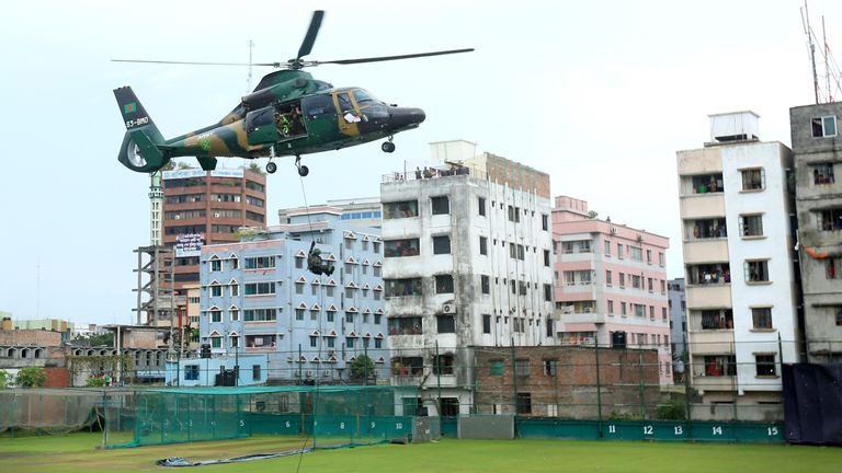 Bangladesh commandos disembark from a hovering helicopter during a mock war game at the Sher-e-Bangla National Stadium in Dhaka on October 6, 2016, a day b