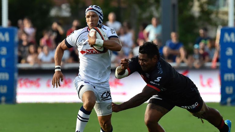 Grenoble's South African wing Gio Aplon (L) vies with Lyon's Tonga centre Hemani Paea during the French Top 14 match Lyon (LOU) versus Grenoble.