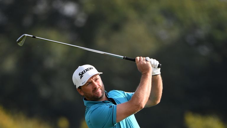 WATFORD, ENGLAND - OCTOBER 15:  Graeme McDowell of Northern Ireland plays his second shot on the eighth hole during the third round of the British Masters 