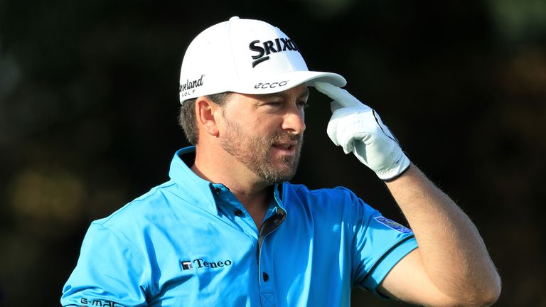 WATFORD, ENGLAND - OCTOBER 15:  Graeme McDowell of Northern Ireland reacts as he walks off the 17th tee during the third round of the British Masters at Th