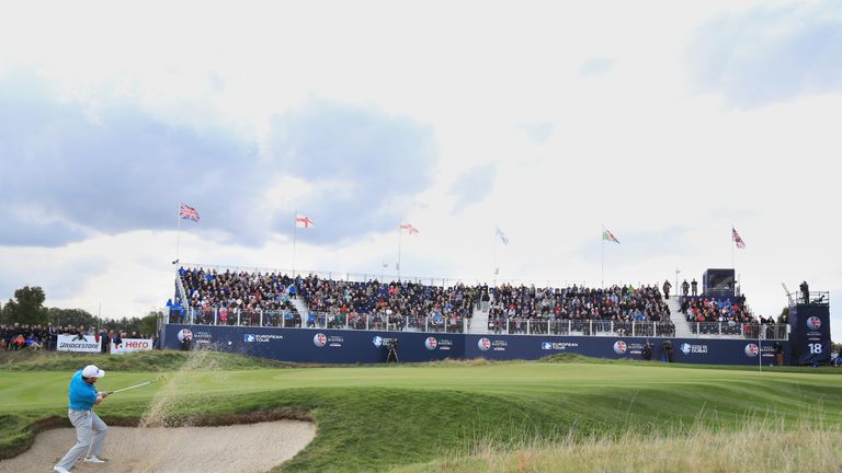 WATFORD, ENGLAND - OCTOBER 15:  Graeme McDowell of Northern Ireland plays his third shot from a bunker on the 18th hole during the third round of the Briti