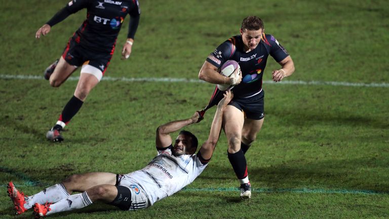 Newport Gwent Dragons' Hallam Amos breaks past Brive's Thomas Laranjeira during the European Challenge Cup, pool three match at Rodney Parade, Newport.
