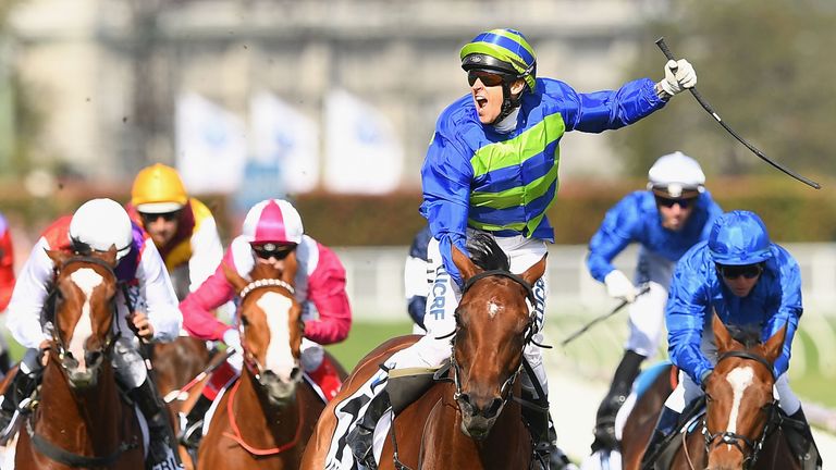 Nicholas Hall  celebrates winning the BMW Caulfield Cup aboard Jameka with Godolphin's Scottish (right) in second place.