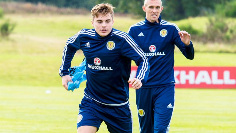 Darren Fletcher watches as James Forrest runs with the ball while training with Scotland