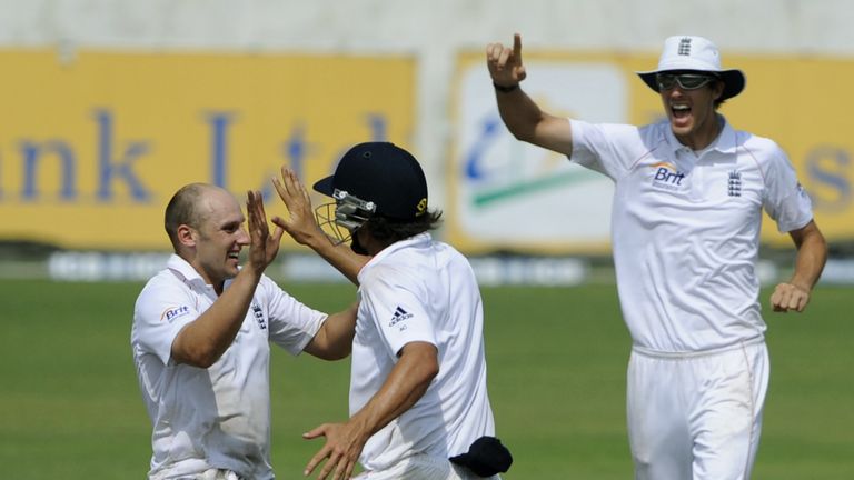 England cricket team captain Alastair Cook (C) celebrates with teammatea James Tredwell (L) and Steven Finn (R) after the dismissal of unseen Bangladeshi b