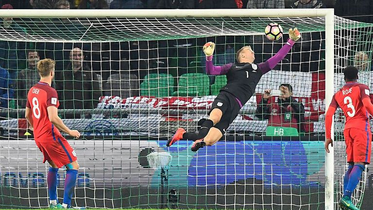 England's goalkeeper Joe Hart (C) makes a save