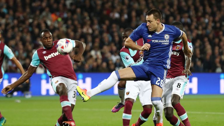  John Terry of Chelsea (R) heads the ball towards goal 