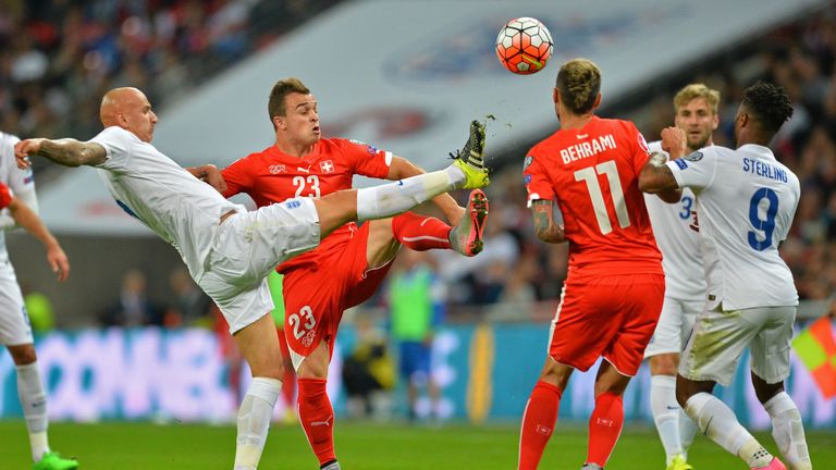 Jonjo Shelvey battles for the ball with Switzerland's Xherdan Shaqiri while playing for England