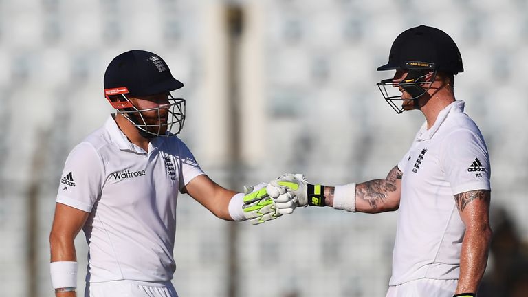 England's Jonny Bairstow (L) and Ben Stokes gesture during the third day's play of the first Test cricket match between Bangladesh and England at Zahur Ahm