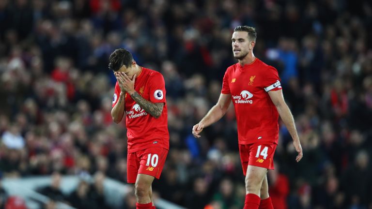 Philippe Coutinho reacts with Liverpool team-mate Jordan Henderson