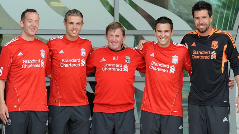 Liverpool's new summer signings Charlie Adam (L), Jordan Henderson (2nd L),Stewart Downing (2nd R) and Alexander Doni (R) pose for pictures with manager Ke