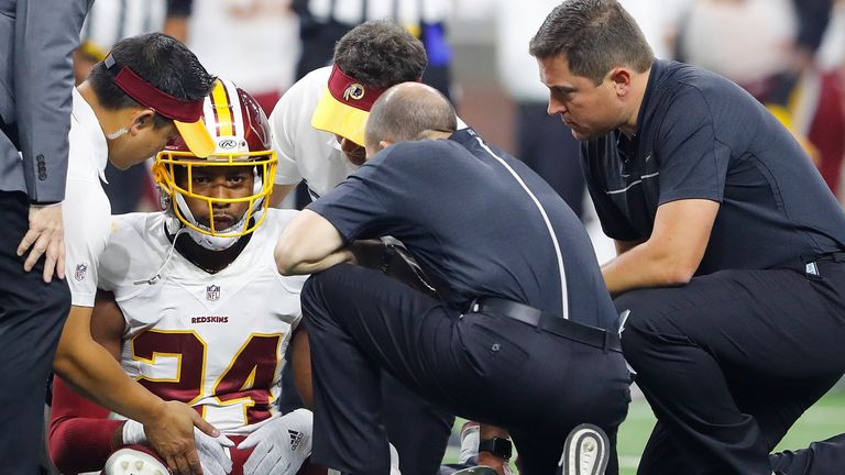 DETROIT, MI - OCTOBER 23: Josh Norman #24 of the Washington Redskins is attended to by staff after being injured during third quarter action against the De