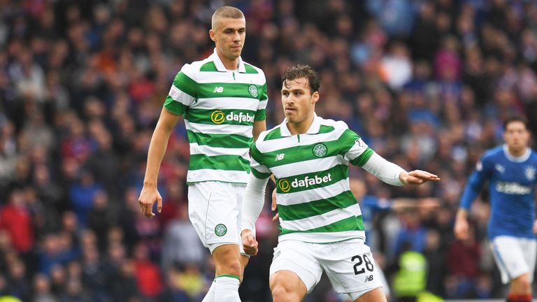 Jozo Simunovic watches as fellow Celtic defender Erik Sviatchenko releases a pass