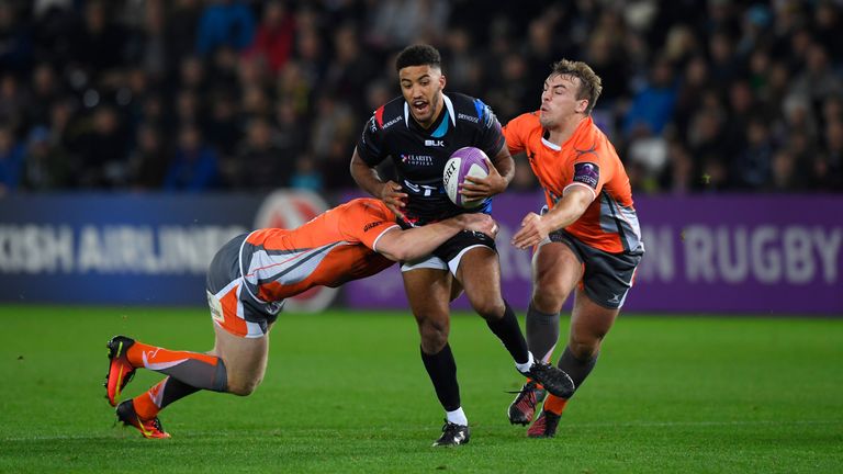 SWANSEA, WALES - OCTOBER 14:  Ospreys Keelan Giles is wrapped up by Freddie Burdon (l) and Craig Willis of the Falcons during the European Rugby Challenge 