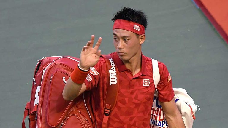 Kei Nishikori offers a rueful wave as he bids farewell to the crowd at the Ariake Colosseum in Tokyo 