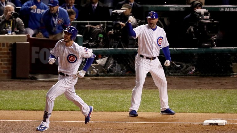 Kris Bryant rounds the bases after hitting a home run in the fourth inning