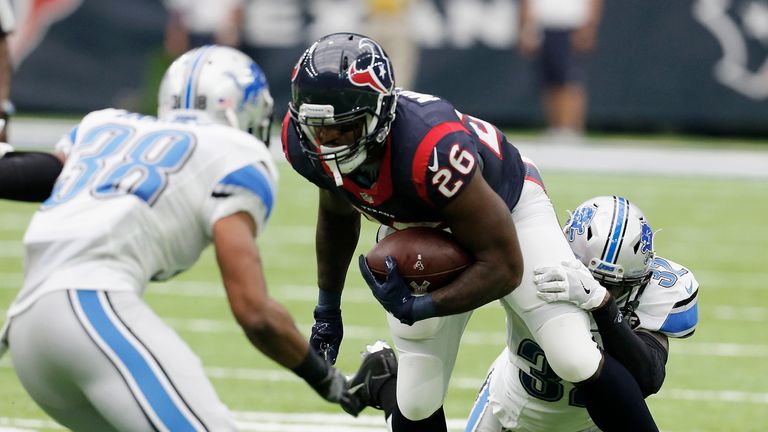 HOUSTON, TX - OCTOBER 30:  Lamar Miller #26 of the Houston Texans is tackled by Tavon Wilson #32 of the Detroit Lions in the second quarter during the game