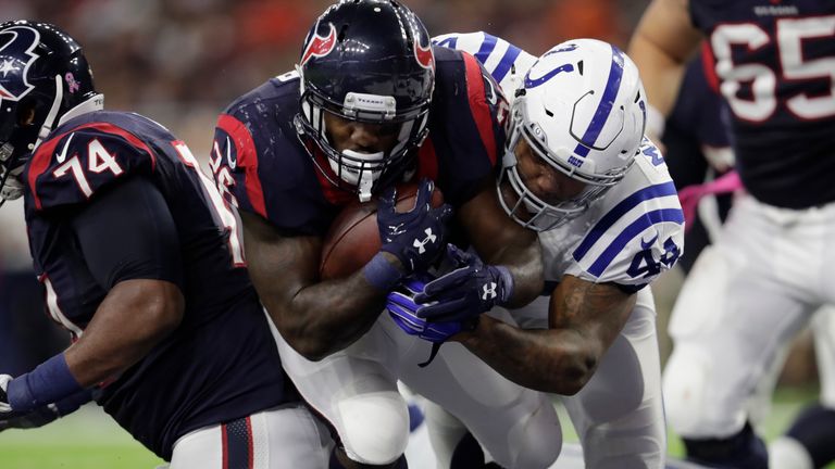 HOUSTON, TX - OCTOBER 16:  Lamar Miller #26 of the Houston Texans carries Antonio Morrison #44 of the Indianapolis Colts across the goal line for a touchdo