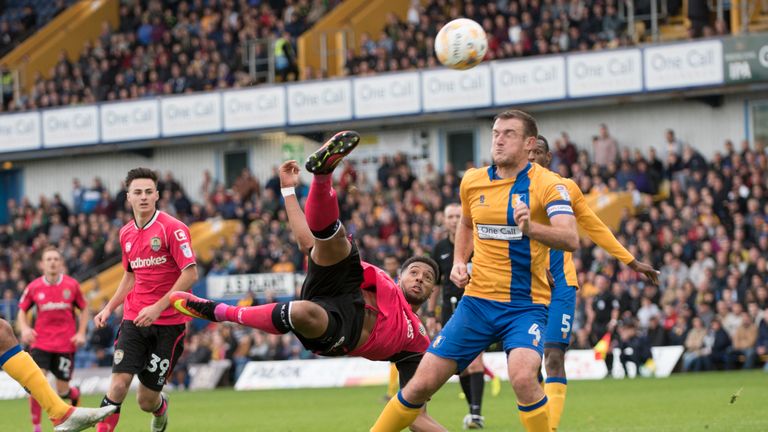 Vadaine Oliver of Notts County and Lee Collins of Mansfield