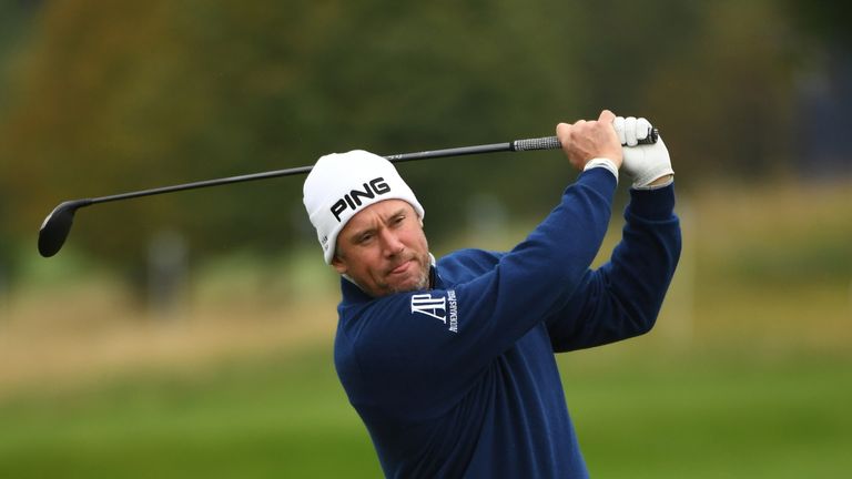 WATFORD, ENGLAND - OCTOBER 13:  Lee Westwood of England plays his second shot on the 18th hole during the first round of the British Masters at The Grove o