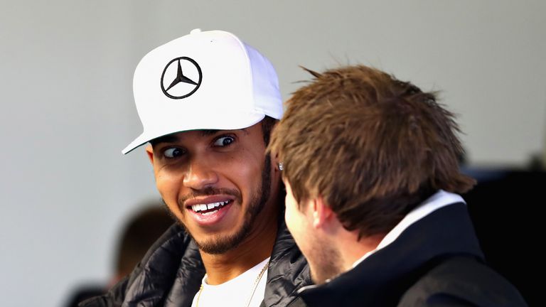 Lewis Hamilton talks to a member of the Mercedes GP team