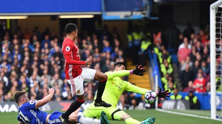Thibaut Courtois of Chelsea makes a save from Jesse Lingard of Manchester United during the Premier League match between Chelsea and Man Utd