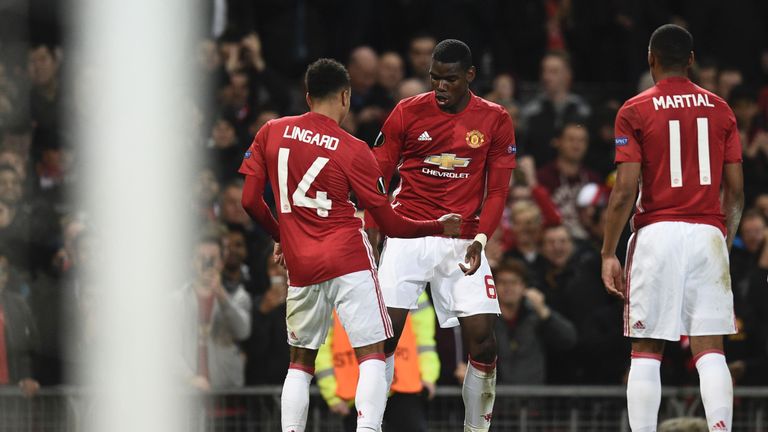 Manchester United's French midfielder Paul Pogba (C) and Manchester United's English midfielder Jesse Lingard (L) do a celebration dance after Pogba scored