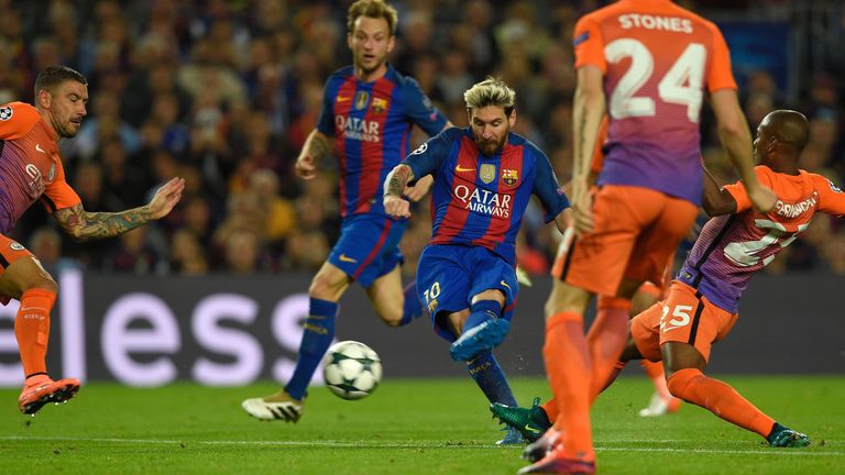 Lionel Messi (C) scores his second goal against Man City