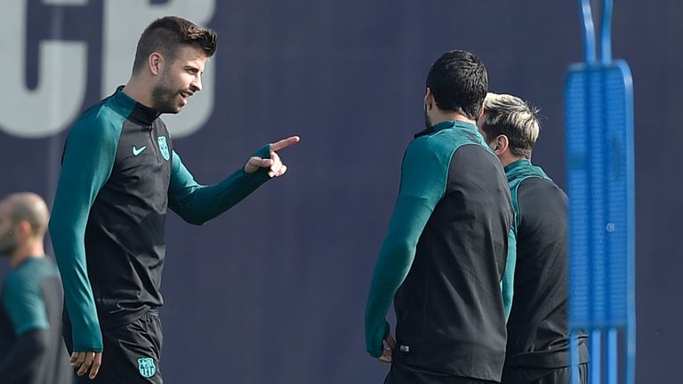 Barcelona's defender Gerard Pique (L) talks with teammates during a training session at the Sports Center FC Barcelona Joan Gamper in Sant Joan Despi, near