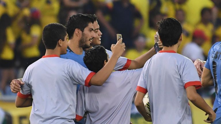 Luis Suarez poses for selfies after the match