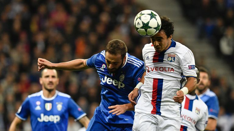 Lyon defender Rafael Da Silva (R) vies with Juventus forward Gonzalo Higuain 