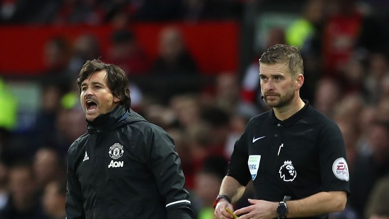 Manchester United assistant manager Rui Faria (L) instructs players during the match against Burnley