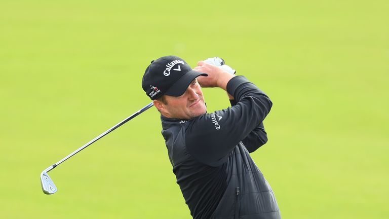 WATFORD, ENGLAND - OCTOBER 13:  Marc Warren of Scotland plays his second shot on the 18th hole during the first round of the British Masters at The Grove o
