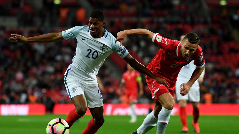  Marcus Rashford holds off pressure from Alex Muscat