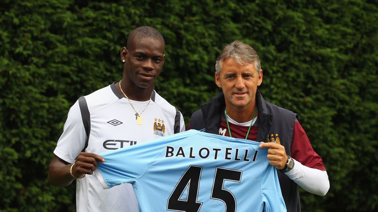 MANCHESTER, ENGLAND - AUGUST 17:  Roberto Mancini the manager of Manchester City unveils his new signing, Mario Balotelli, at the Carrington Training Compl