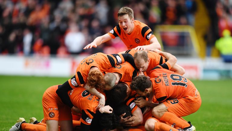 Mark Durnan is mobbed by his team-mates after scoring Dundee United's winner against Falkirk