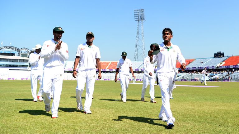Mehedi Hasan leads his team from the field after taking six wickets against England