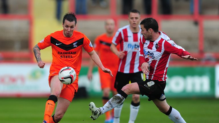 EXETER, ENGLAND - APRIL 26:  Michael Collins of Scunthorpe United (L) holds off Matt Oakley of Exeter City during the Sky Bet League Two match between Exet