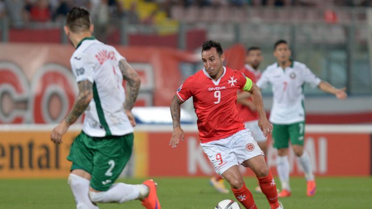 Malta captain Michael Mifsud (R) tries to make his way through the Bulgarian defence during their 2016 UEFA European Championship qualifying football match